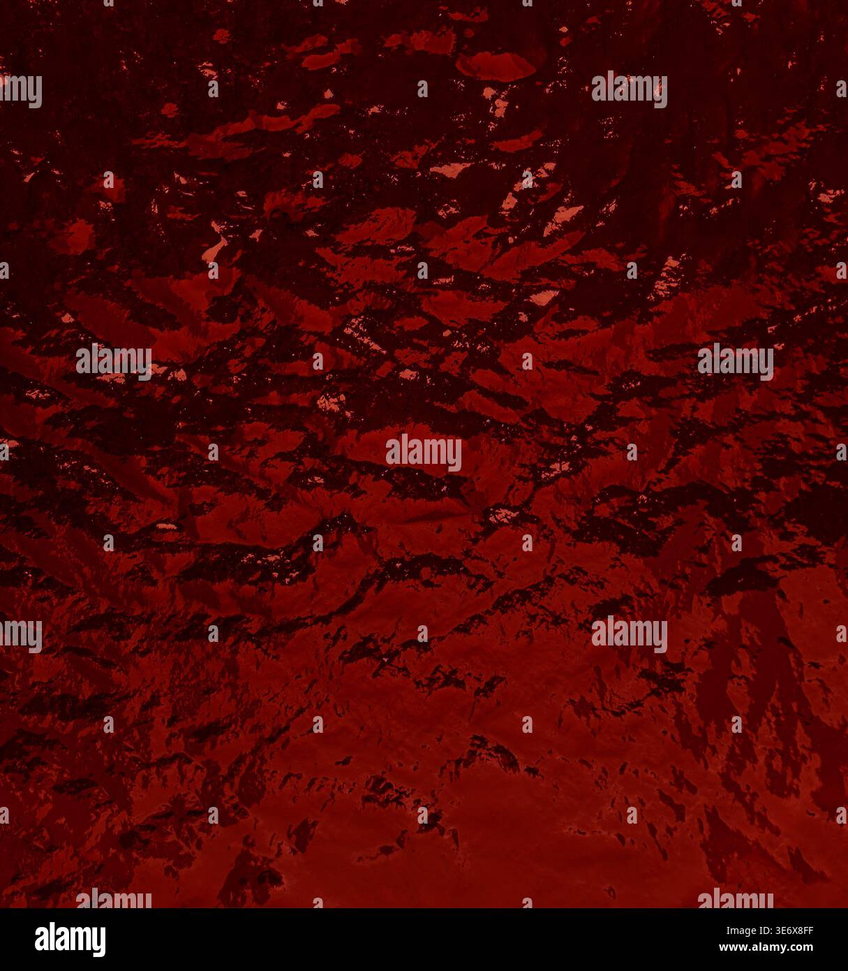 Dark red liquid surface ripples, creating an abstract background texture Stock Photo