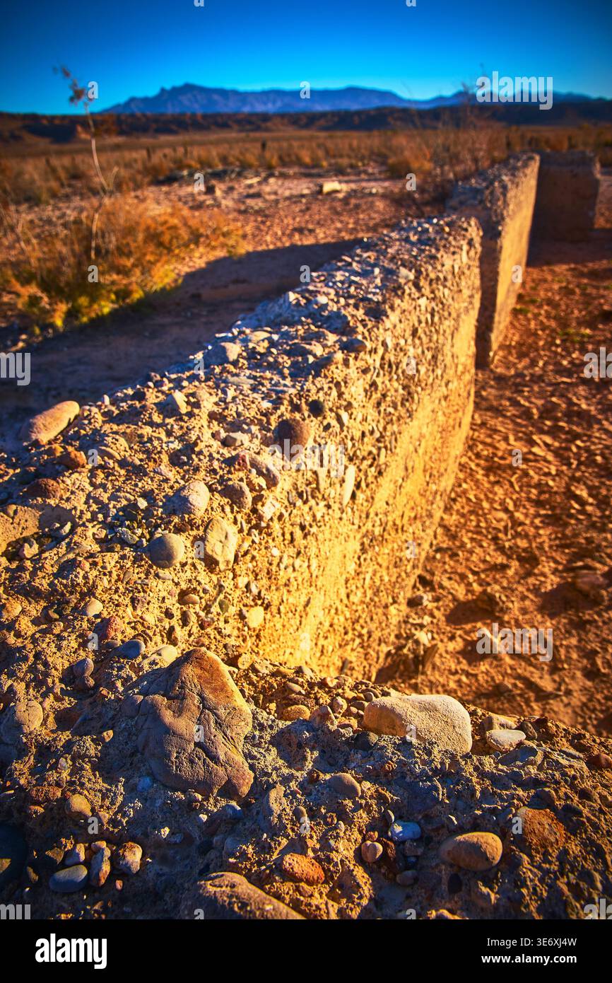 Old Stone Wall Ruin in Desert Ghost Town Nevada Mountains in Distance Stock Photo