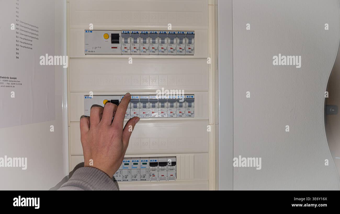 Hand operating circuit breaker in residential electrical panel. Concept ...