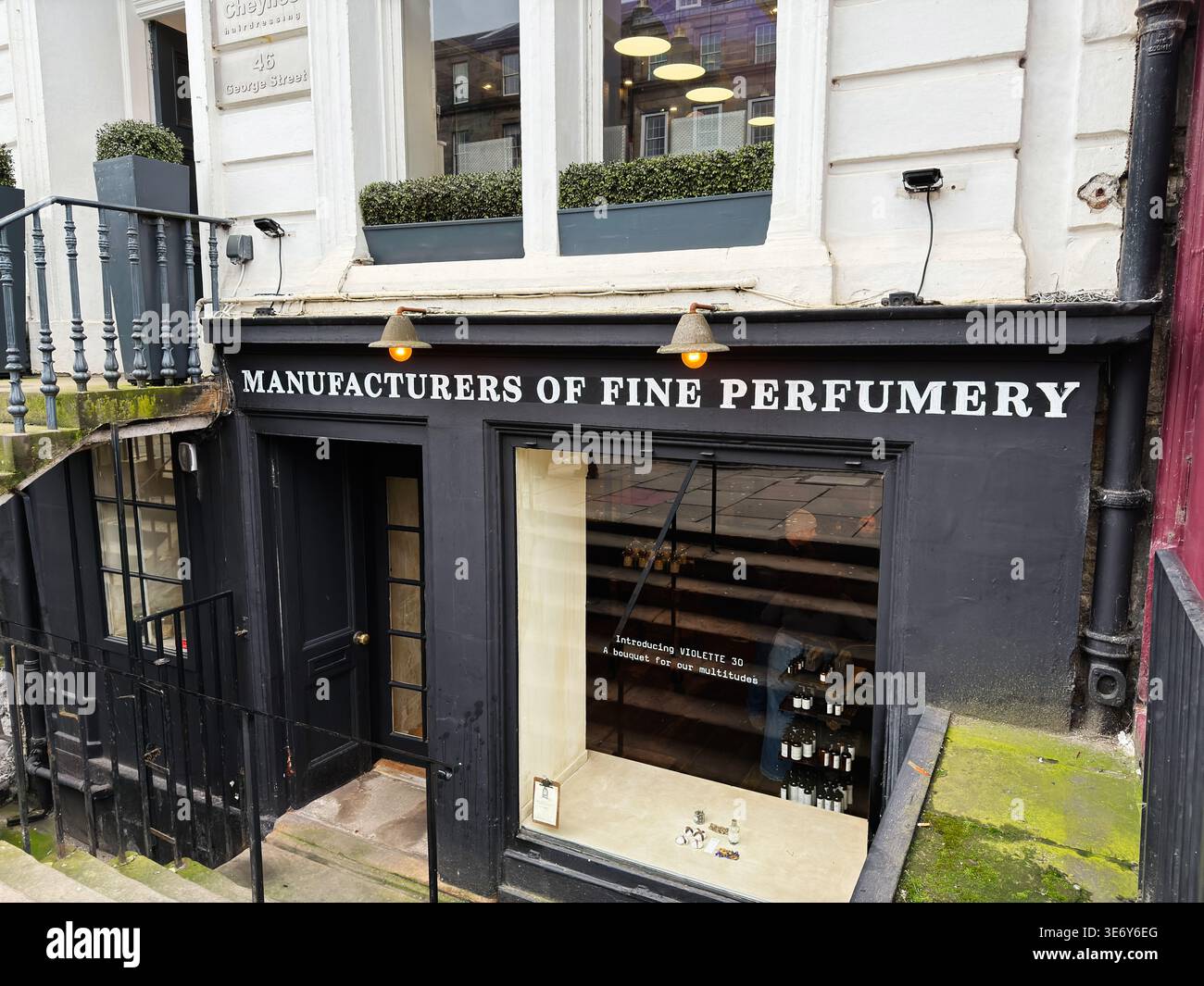 Edinburgh, Scotland, UK - February 16, 2026: Black perfumery storefront in Edinburgh, Scotland, UK with window display, stone steps and vintage signag Stock Photo