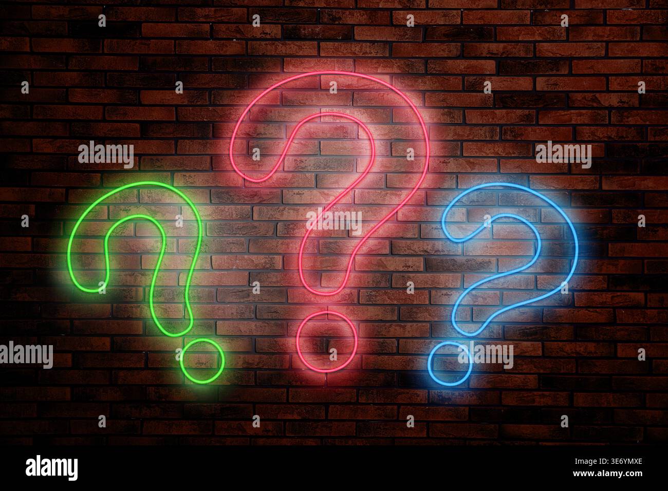 Three neon question marks on brick wall Stock Photo