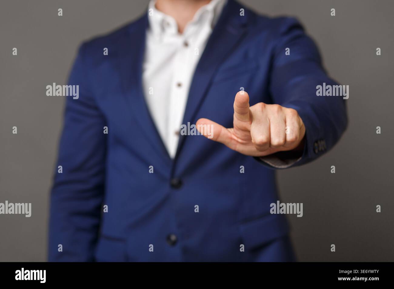 Businessman pushing button on blank virtual screen Stock Photo