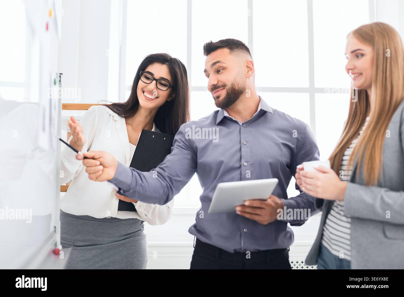 Confident colleagues discussing new project in office Stock Photo
