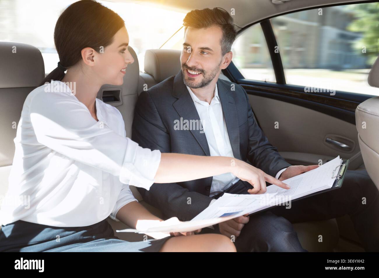 Business partners working with documents in car Stock Photo