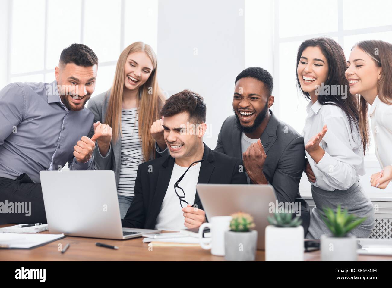 Happy multinational young managers completed hard project Stock Photo