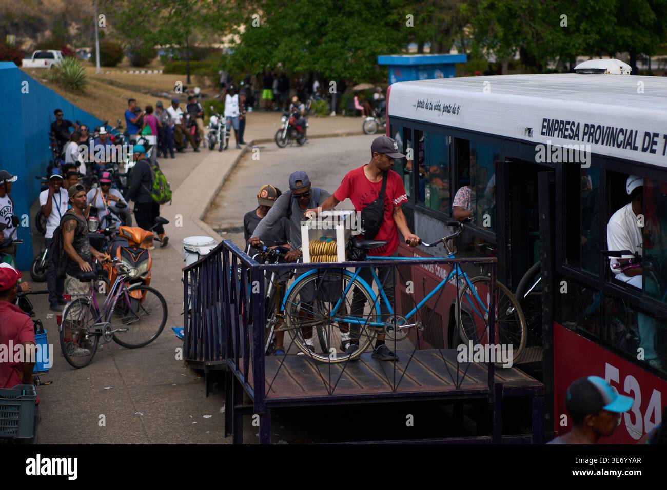 People load their bicycles onto a public bus to cross the Bay Tunnel in ...