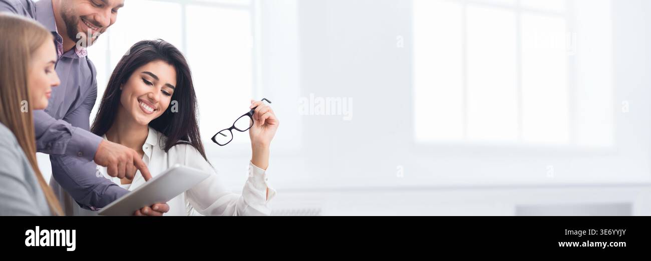 Happy business colleagues discussing new project in office Stock Photo