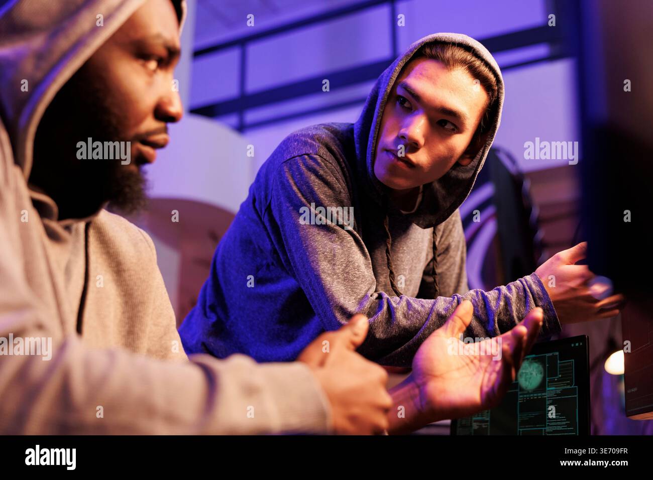 Hackers discussing criminal activity and malicious plan to breach database. Illegal malware developers talking about ransomware code for stealing confidential data and cracking password Stock Photo