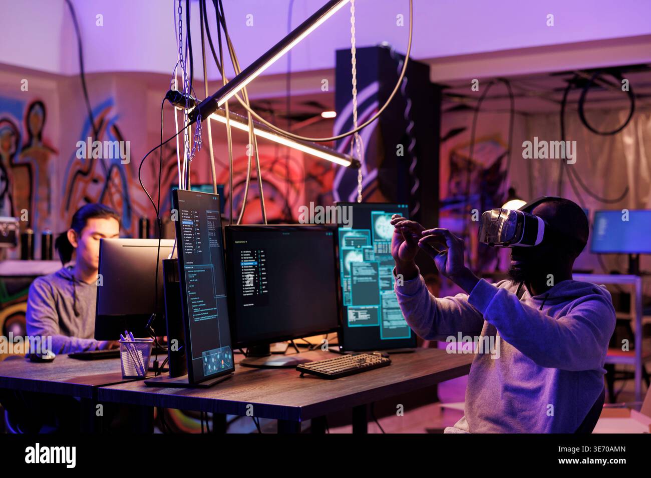 Criminal hacking using vr technology and breaking into server while exploring metaverse. Hacker in virtual reality headset doing illegal activity and programming malicious software Stock Photo