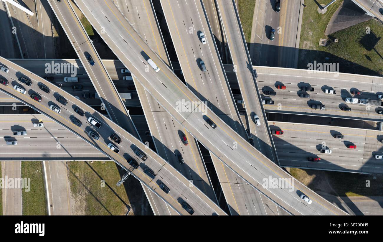 Overhead view of a large multilane highway interchange with many cars driving Stock Photo
