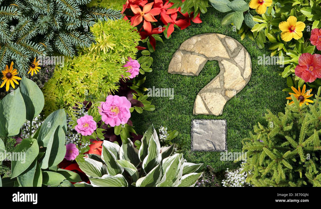Gardening questions and garden advice with an ornamental landscaped flowerbed and spring gardening concept shaped as a question mark with a mowed lawn Stock Photo