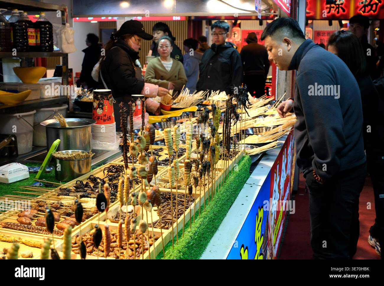 A vendor sells 'insect skewers' at Xing Shun Night Market in Shenyang ...