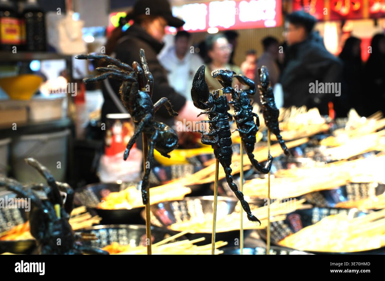 A vendor sells 'insect skewers' at Xing Shun Night Market in Shenyang ...