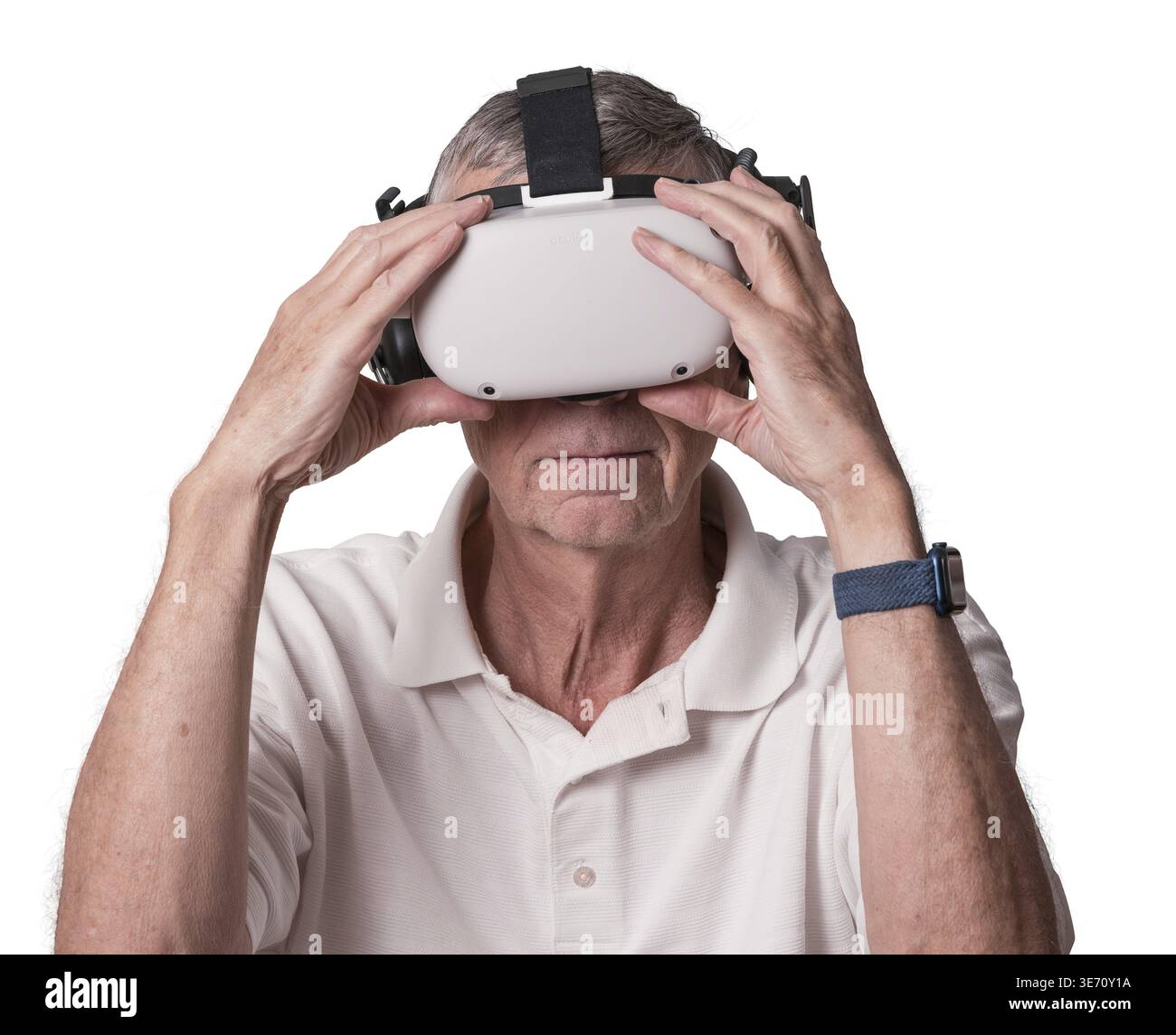 Senior adult man holding his virtual reality headset while exploring a scene in the metaverse Stock Photo