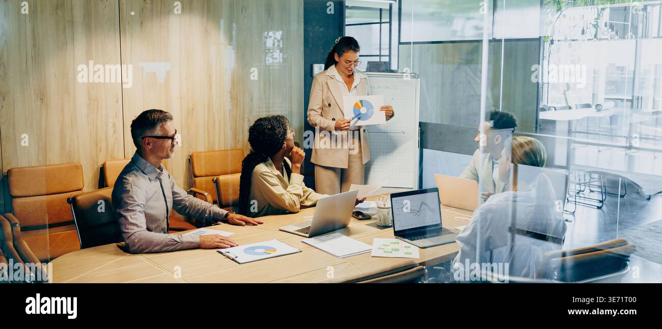 Team engaging in creative activity using whiteboard and sticky notes Stock Photo