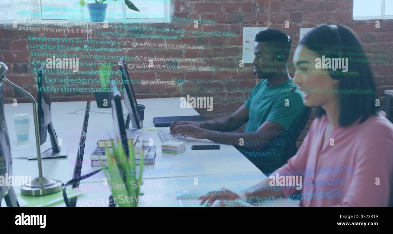 Typing coworkers in pink blouse, teal t-shirt, coding on monitors at open office with code overlay. Teamwork, programming, developers, screens, desk, Stock Photo
