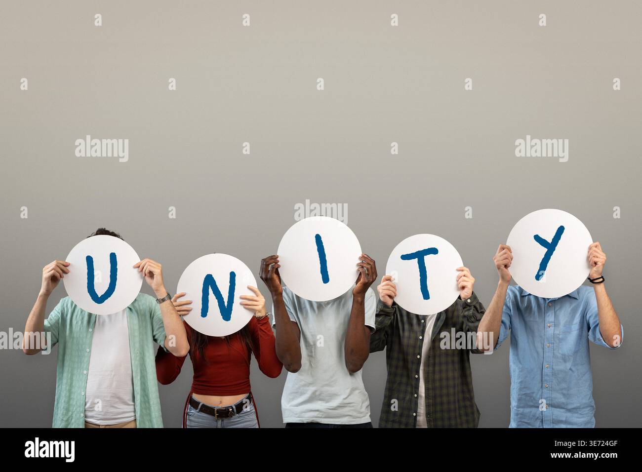Multicultural Signs Multicultural group holding round signs forming the word unity, concept ...