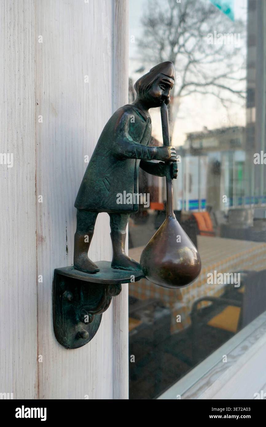 Door knocker glassblower figure Stock Photo