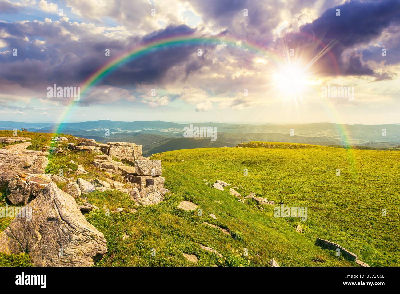 sunset over mountainous landscape during summertime. boulders and rock formations surrounded grassy hills. picture of an untouched highland. leadershi Stock Photo