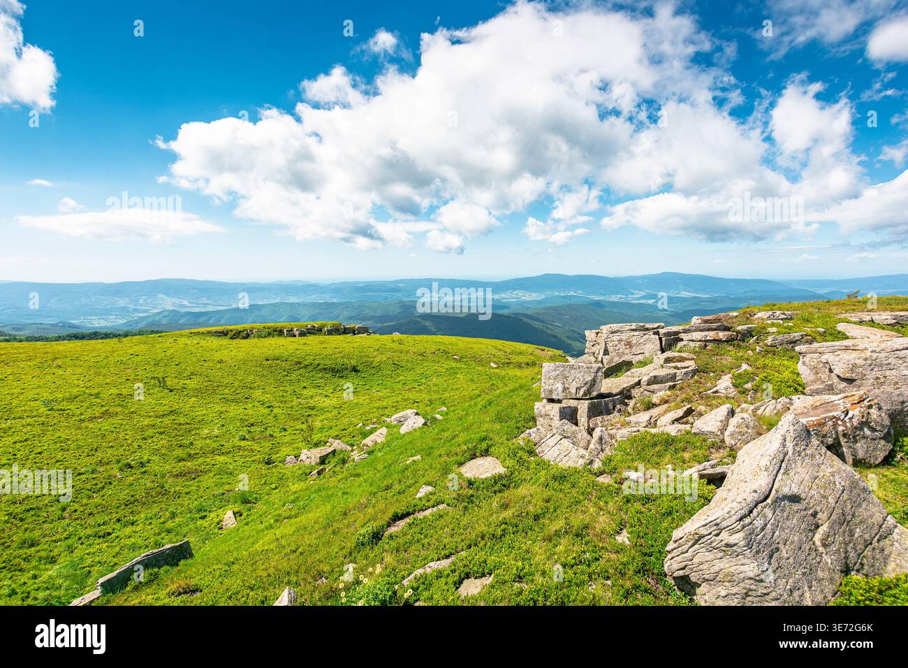 mountainous carpathian landscape during summertime. boulders and rock formations surrounded grassy hills. picture of a sunny forenoon with clouds on t Stock Photo