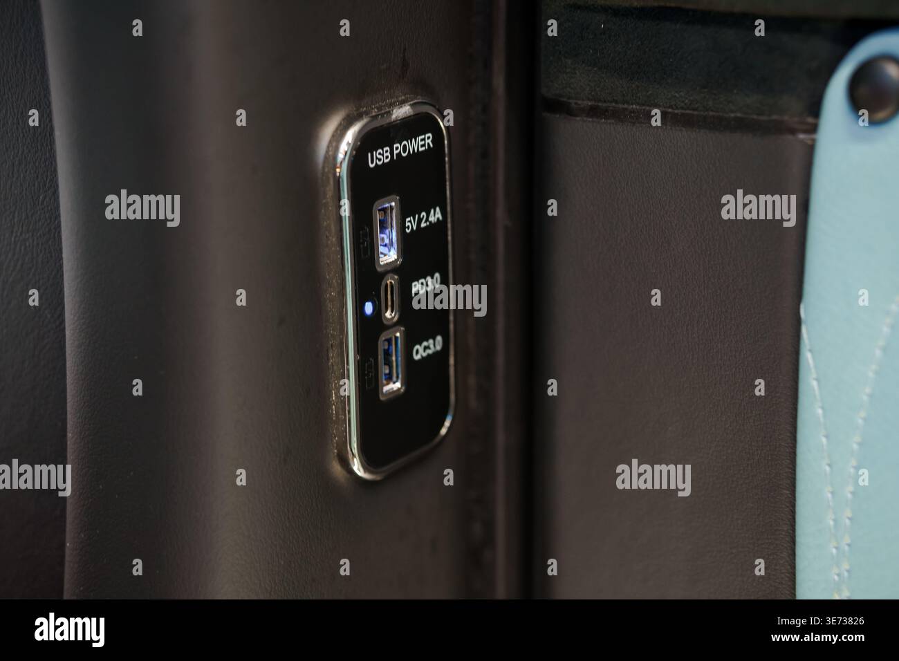 A detailed view of dual charging ports installed in a vehicle interior for mobile device power Stock Photo