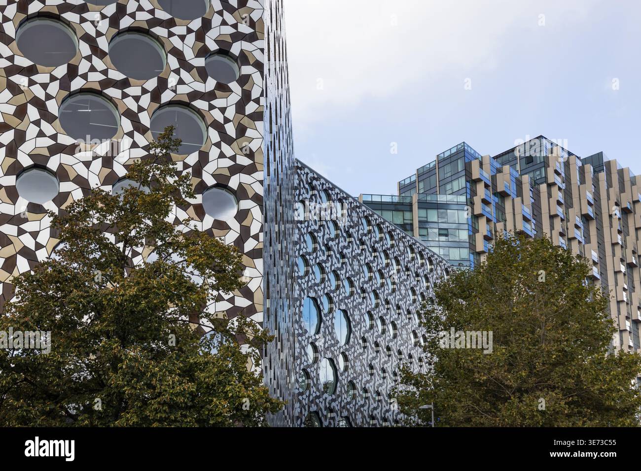 Modern building facade with geometric metal ring patterns Stock Photo