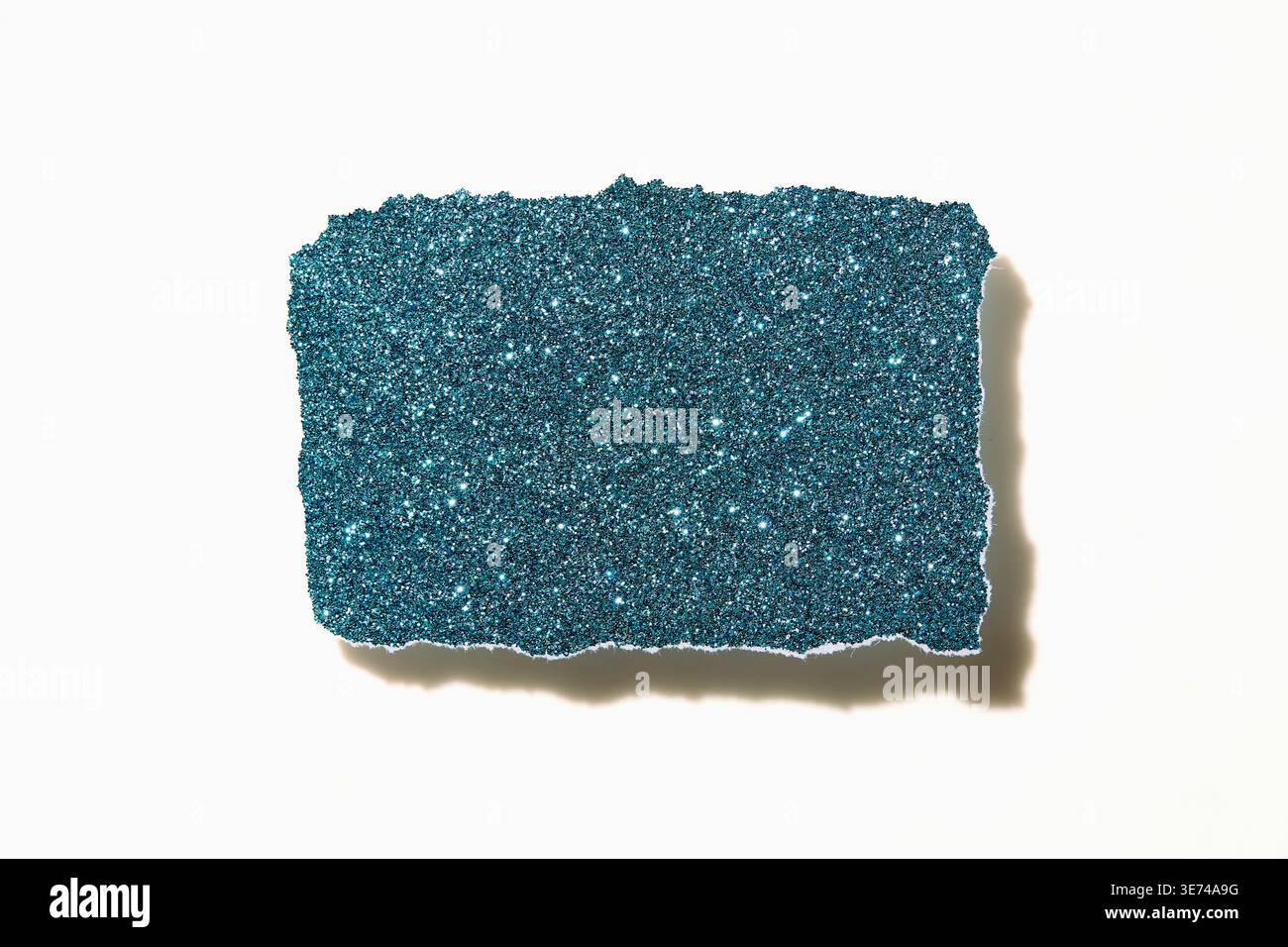 Torn blue glitter paper on white background Stock Photo