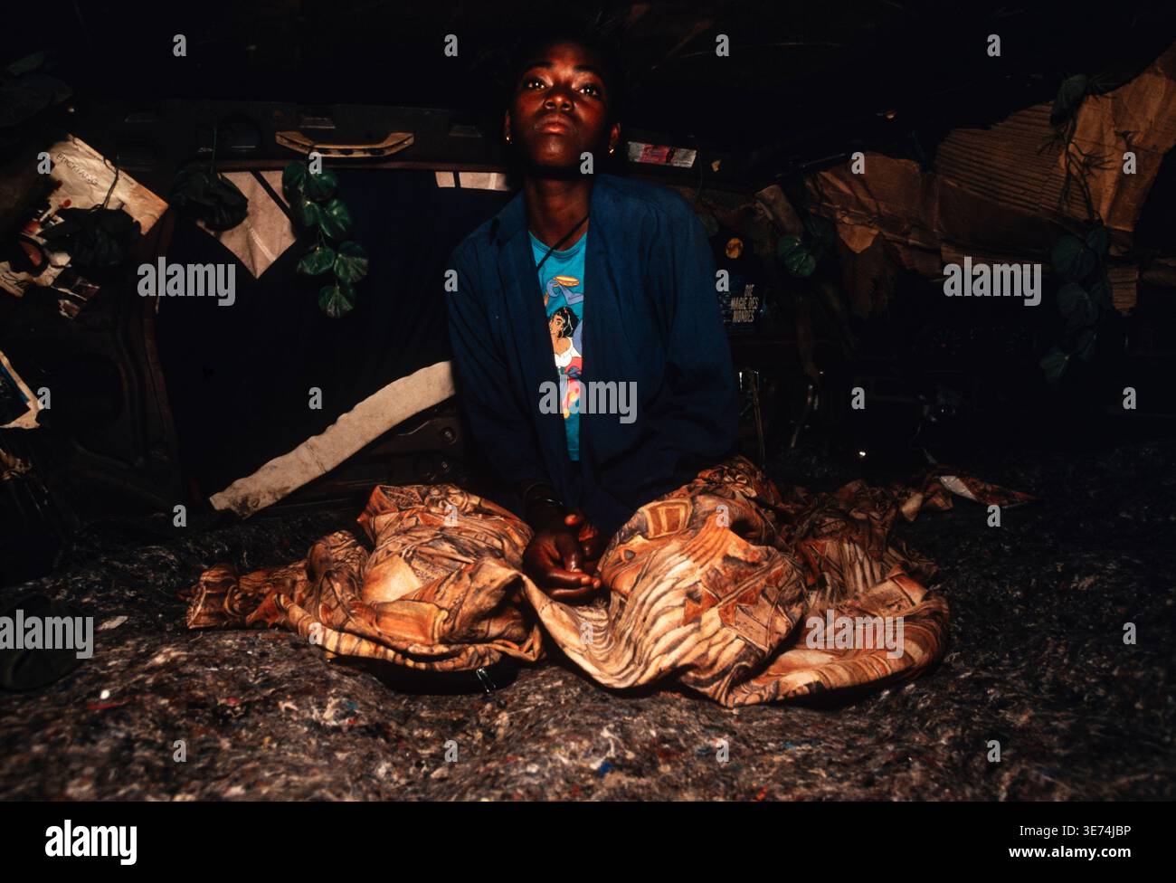 Homeless girl living in a dumped car is encouraged to join a night class by a local charity, Luanda, Angola Stock Photo