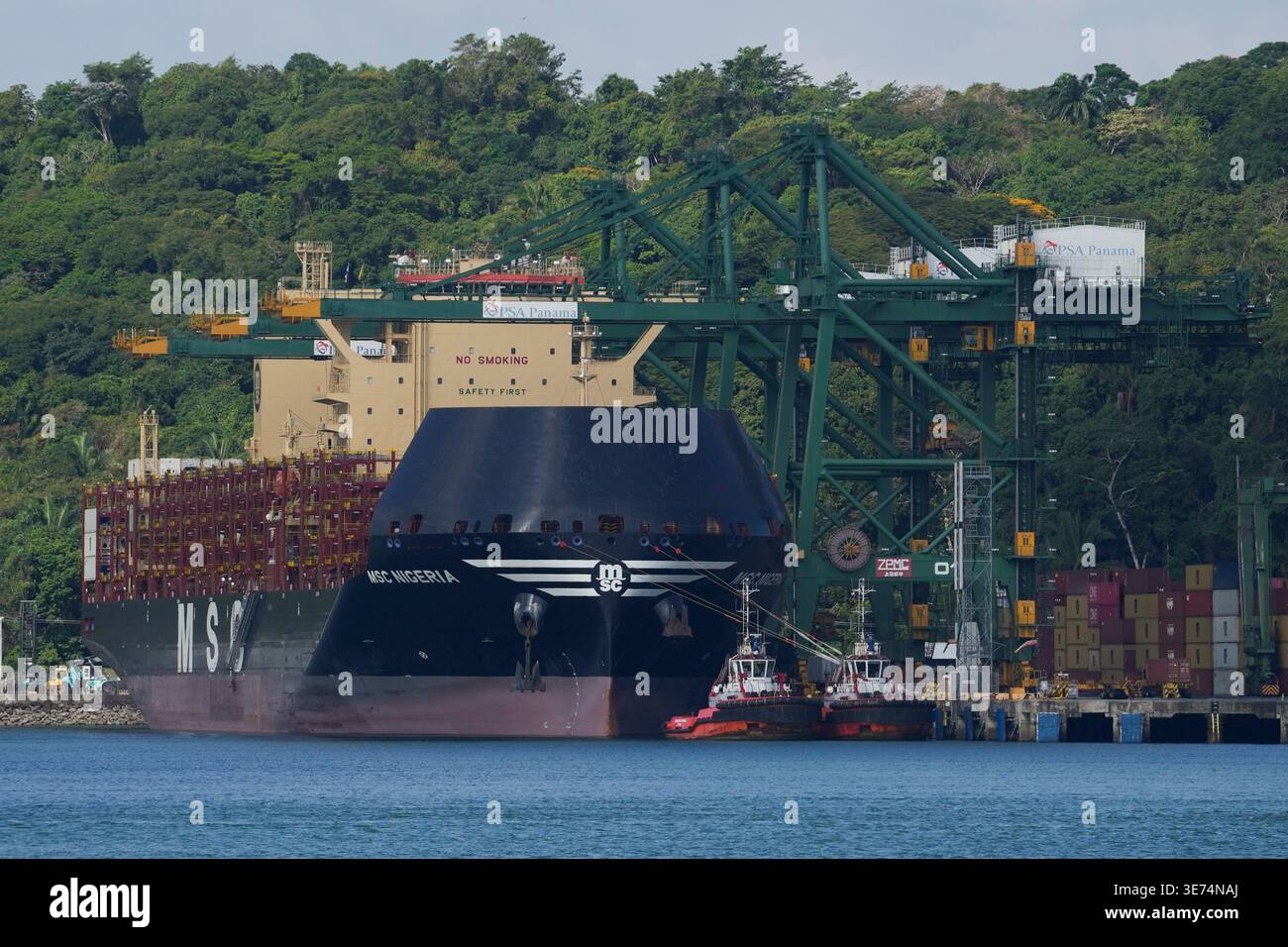 Cranes load and unload containers from cargo ships at the Panama Canal ...