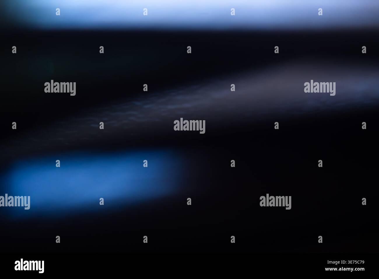 Dark abstract background with soft blue light flares and deep shadows Stock Photo