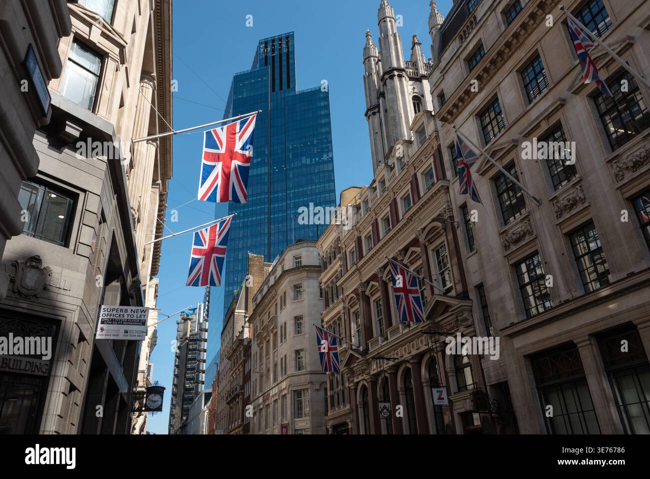 London street scene in financial district with modern building and british flag Stock Photo