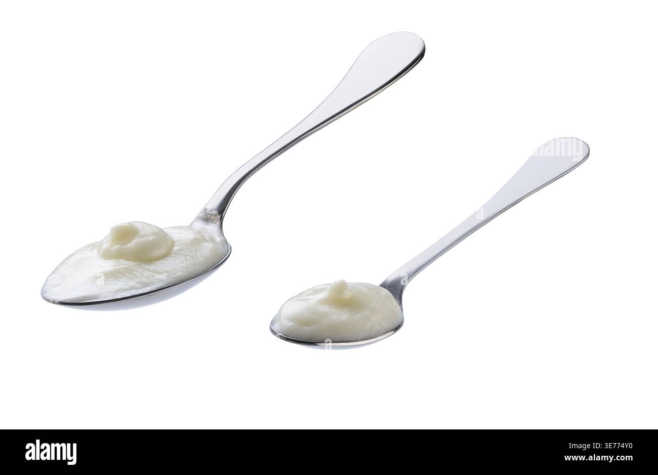 Probiotic yogurt in a metal spoon isolated on a white background Stock Photo