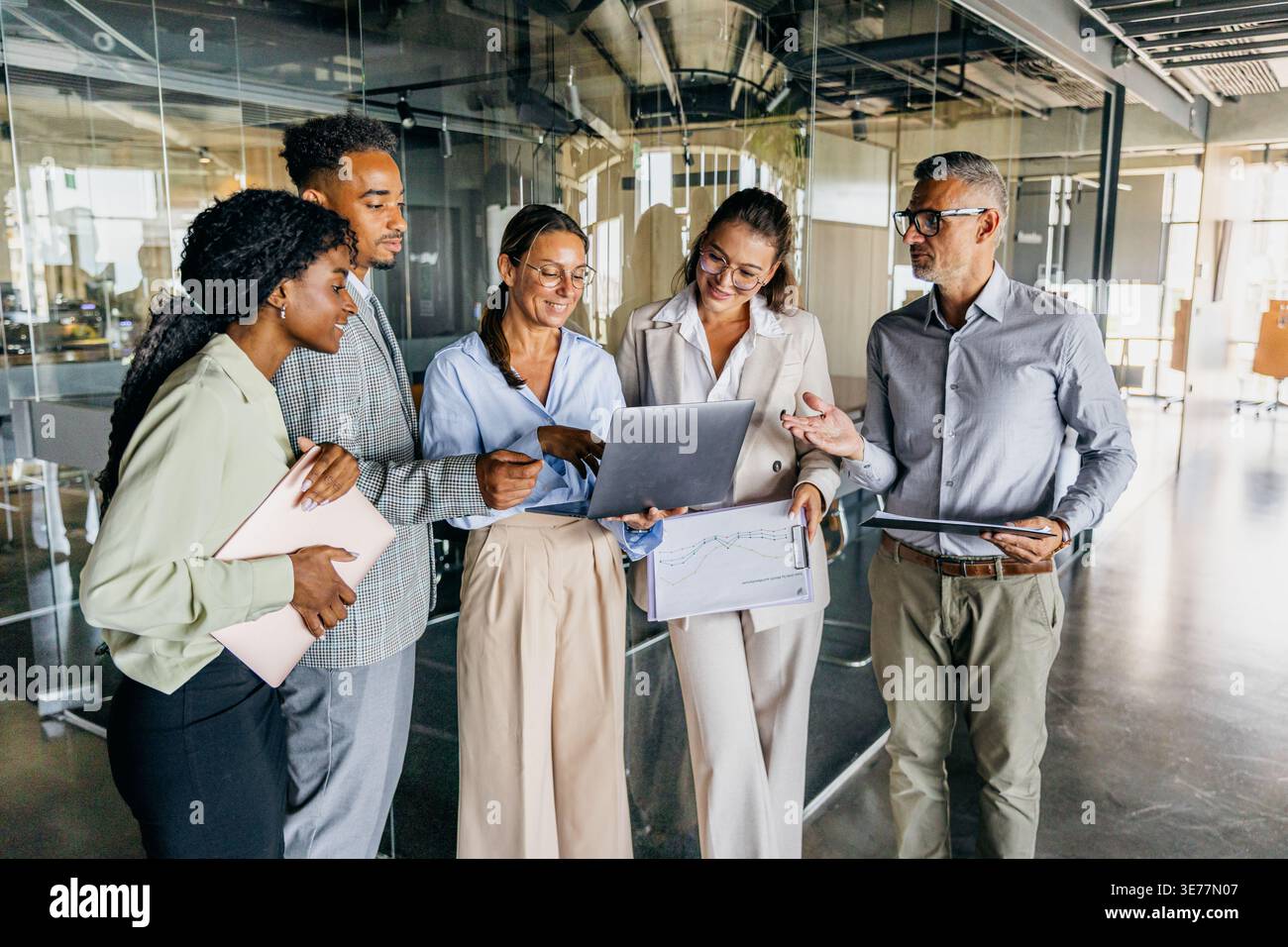 Development team reviews demonstration while smiling and planning features Stock Photo