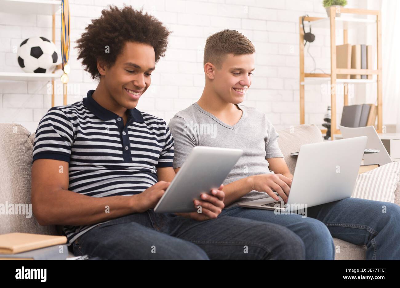 Young guys studying for exams at home Stock Photo