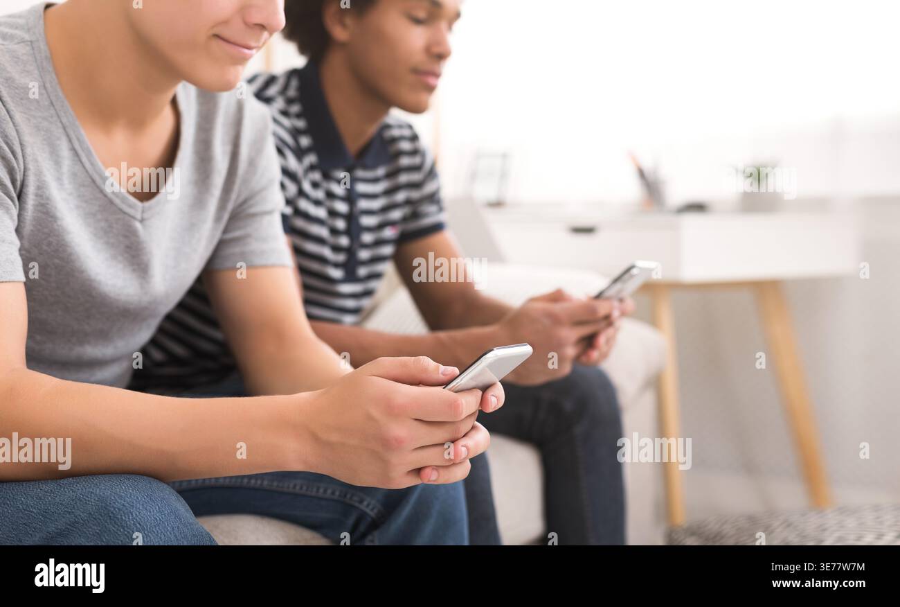 Diverse friends using smartphones while sitting at home Stock Photo