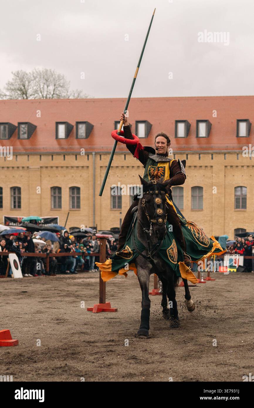 Medieval Post Rider Berlin, Germany - April 5, 2026: a mounted rider lifts a ring jousting ...
