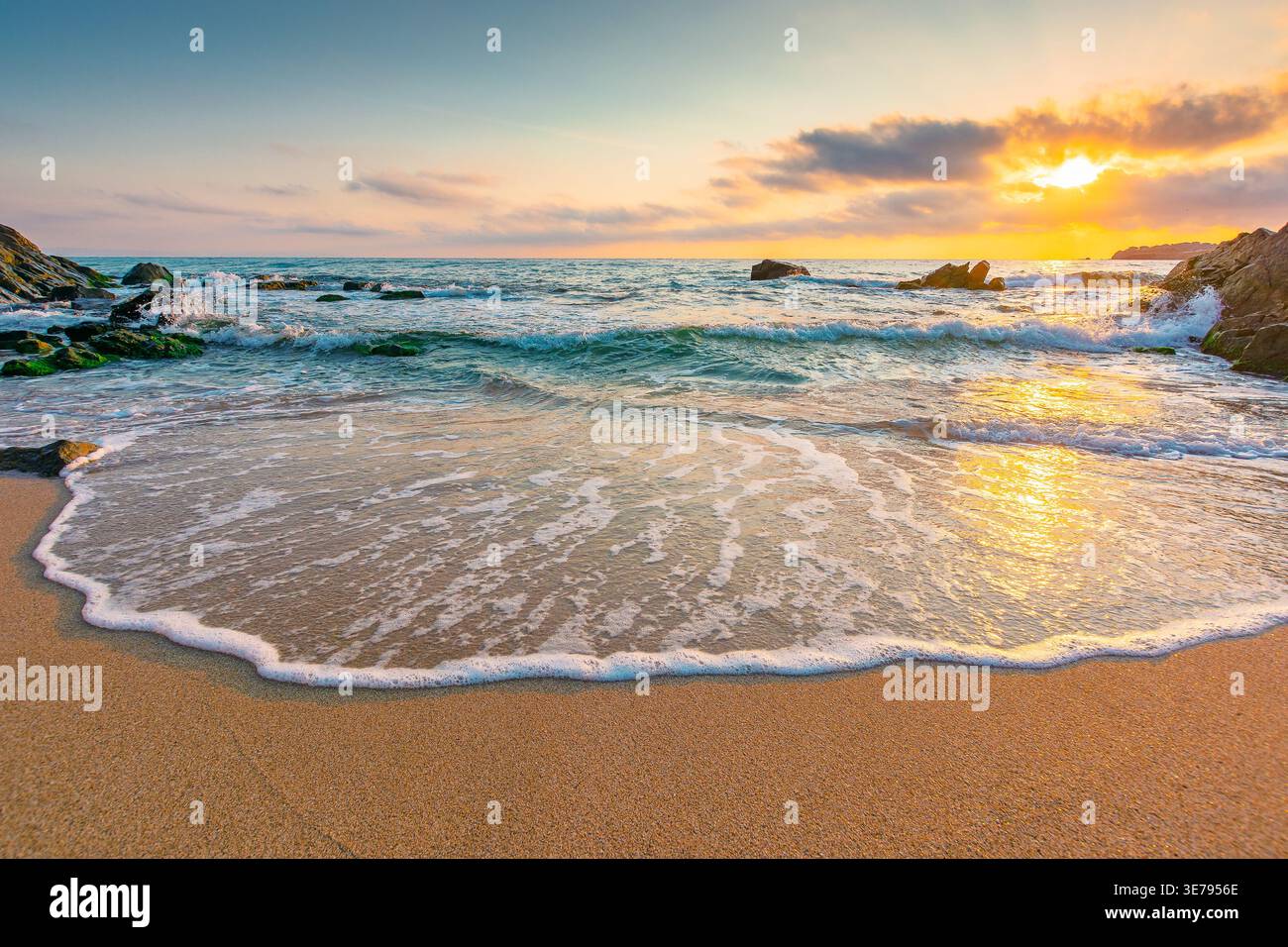 sandy beach of a black sea at sunrise. bulgaria scene on hot summer vacation season. beautiful view of waves washing the sand in morning light. generi Stock Photo