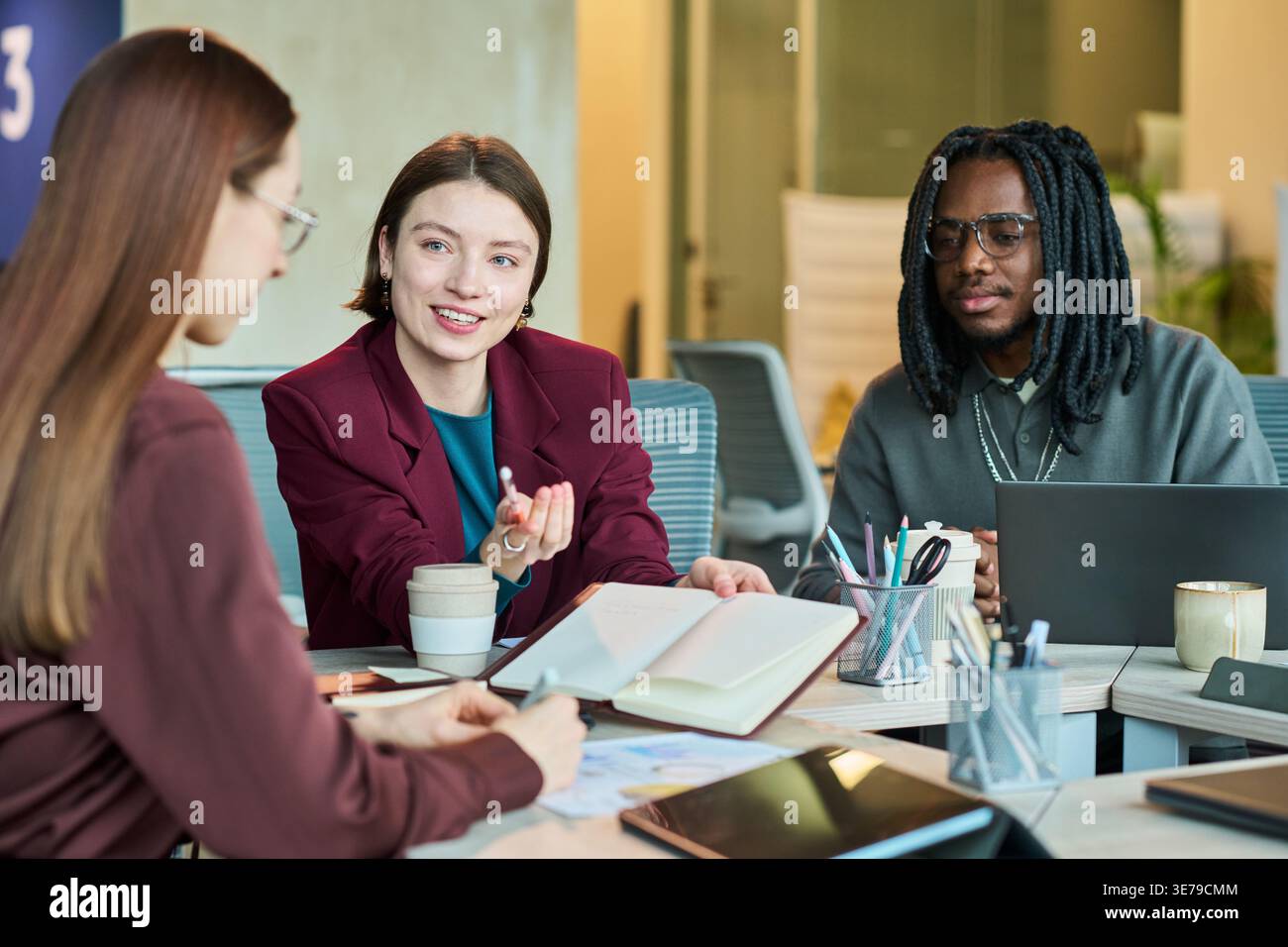 Diverse Business Team Collaborating during Office Strategy Meeting Stock Photo