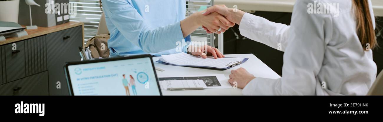 Header of Doctor Shaking Hands with Patient during Consultation Stock Photo