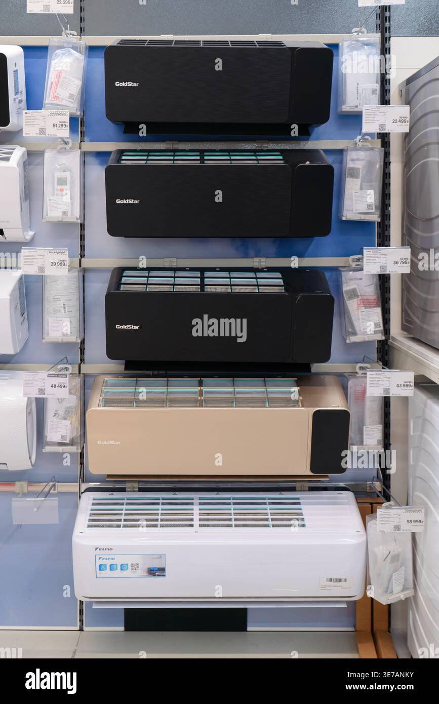 RUSSIA, Ufa - March 27, 2026: Tsentralnyy Trading Complex. Display case with black, gold, and white split-system air conditioners on display at an M.V Stock Photo