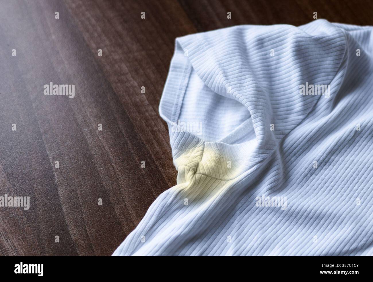 Close-Up of Yellow Sweat Stain on White T-Shirt. Stock Photo