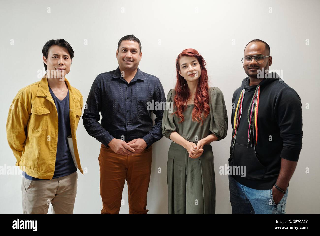 Group of software developers standing against while wall in office Stock Photo