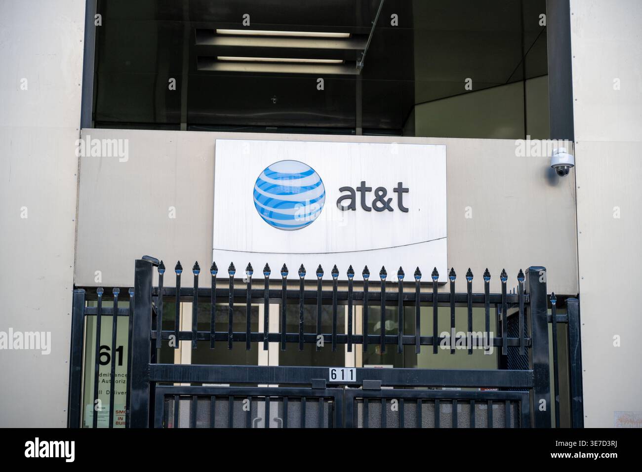 AT&T facility entrance with logo sign, security gate, and surveillance ...