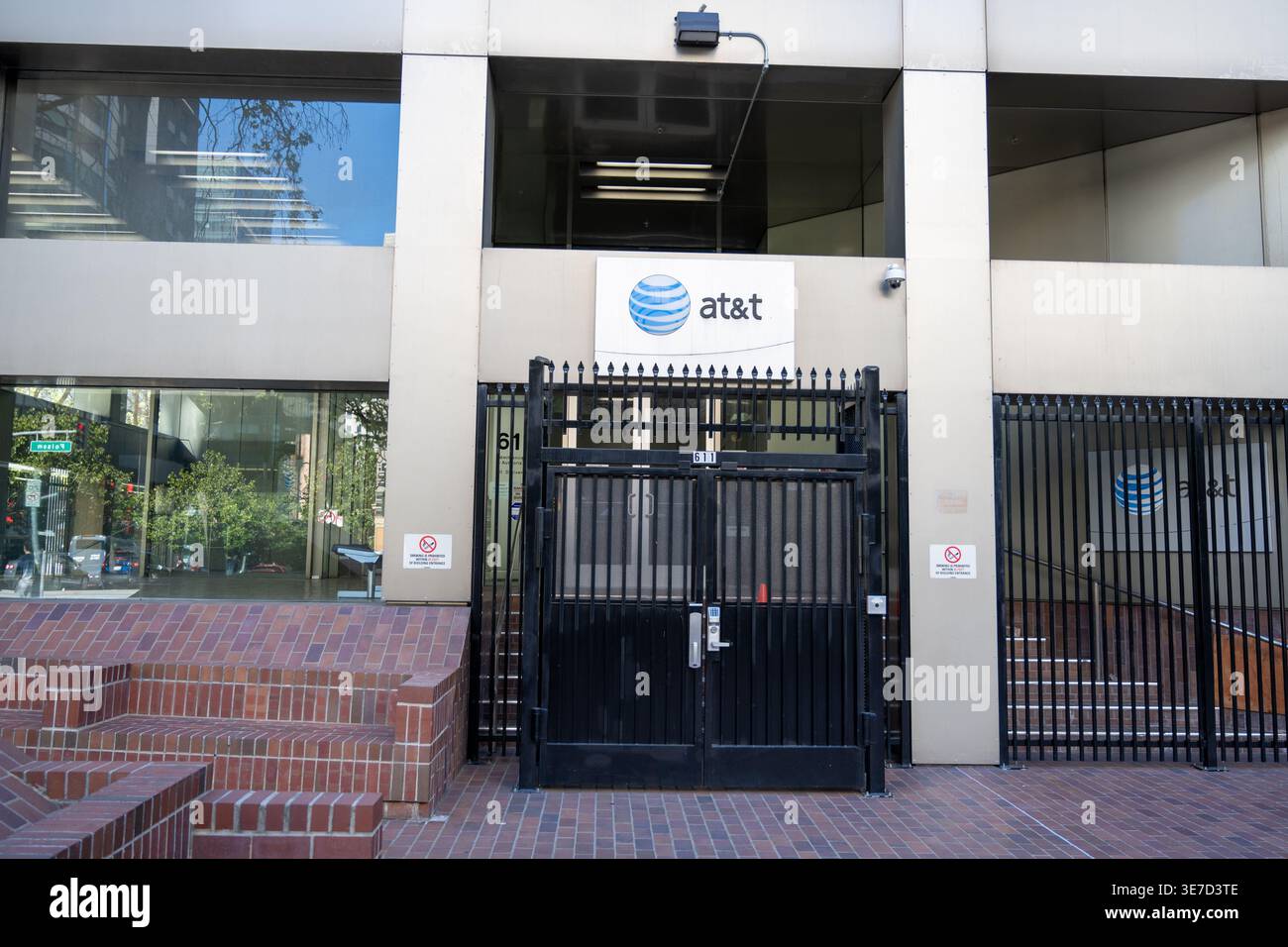 AT&T facility entrance with logo sign, security gate, and surveillance ...