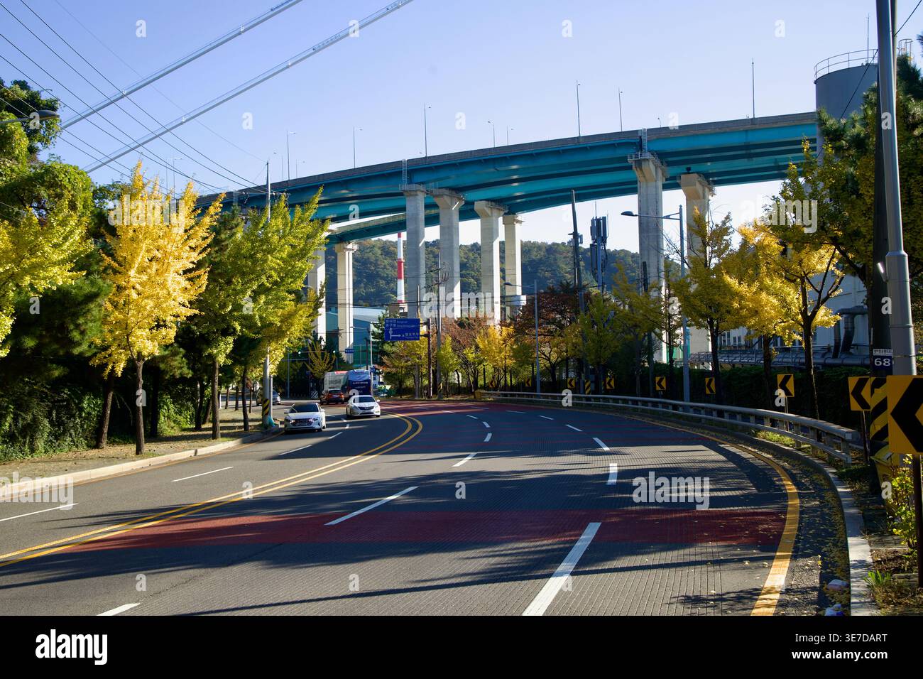 Tall Bridge Off Ramp A broad curve of roadway passes beneath tall approach ramps to Ulsan ...