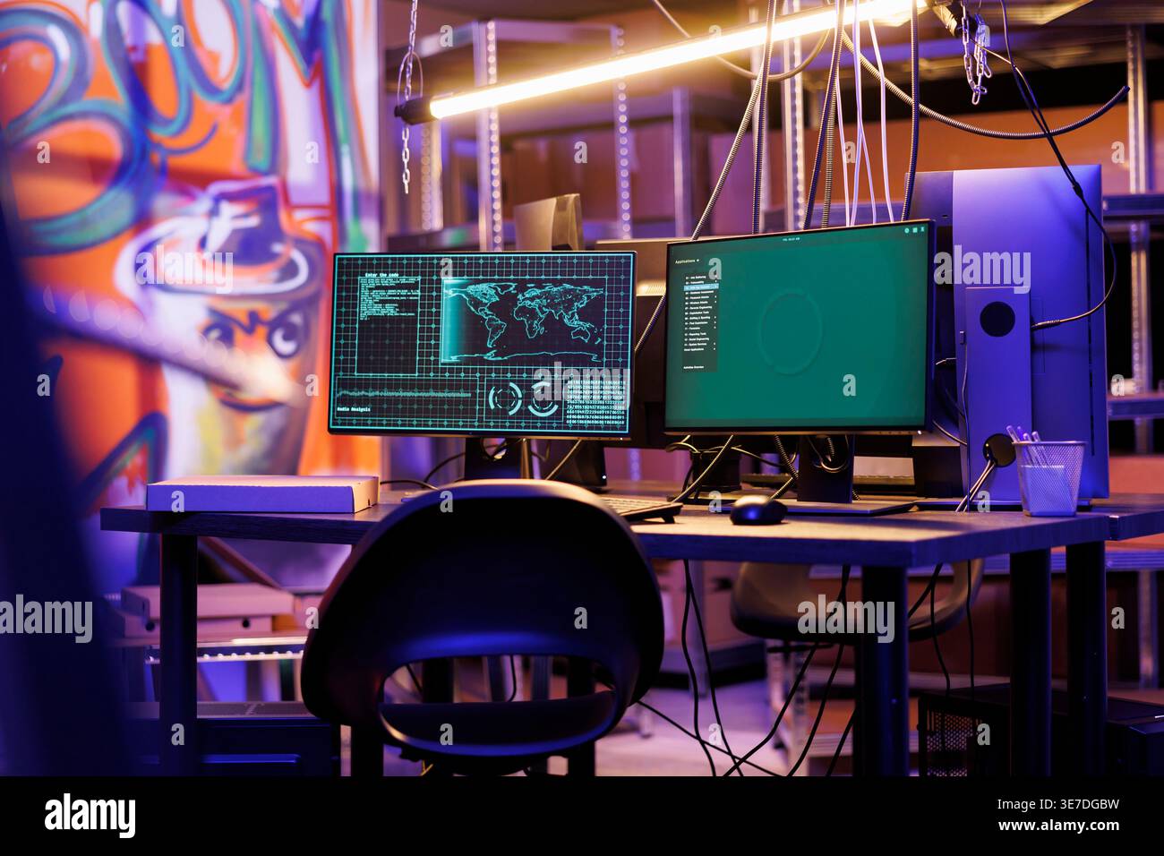 Malicious software on computer screen hacking server in abandoned warehouse at night time. Ransomware stealing information and breaking into database on monitor in hackers hideout Stock Photo