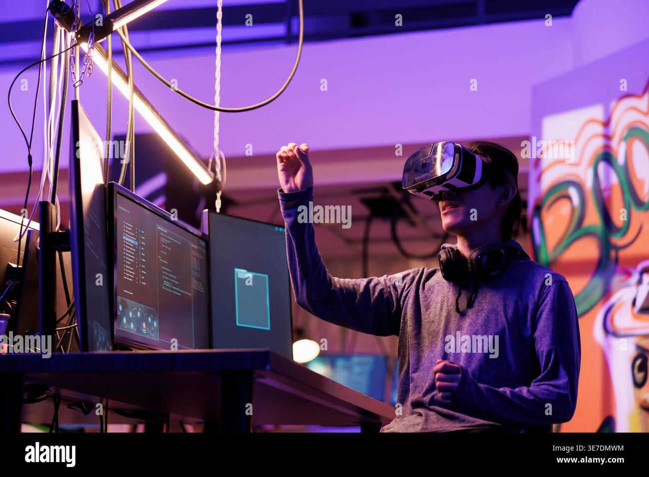 Hacker doing illegal activity in vr headset and exploring metaverse while breaking law. Criminal hacking server in virtual reality simulation while making gestures with hands Stock Photo