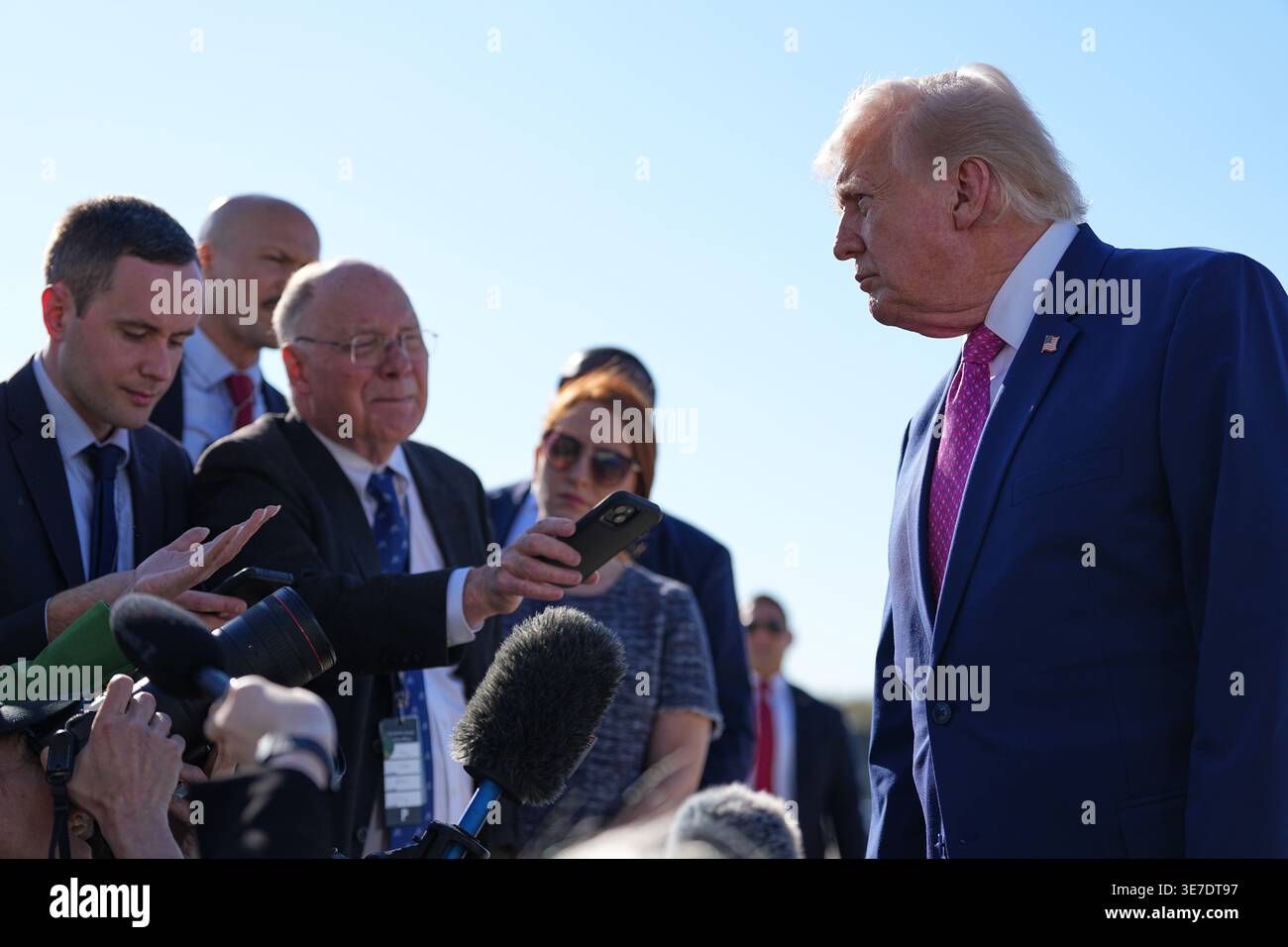 President Donald Trump talks with reporters before boarding Air Force ...