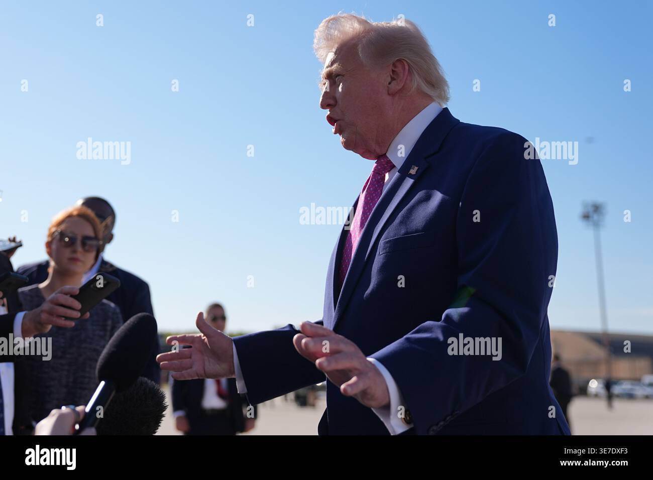 President Donald Trump talks with reporters before boarding Air Force ...