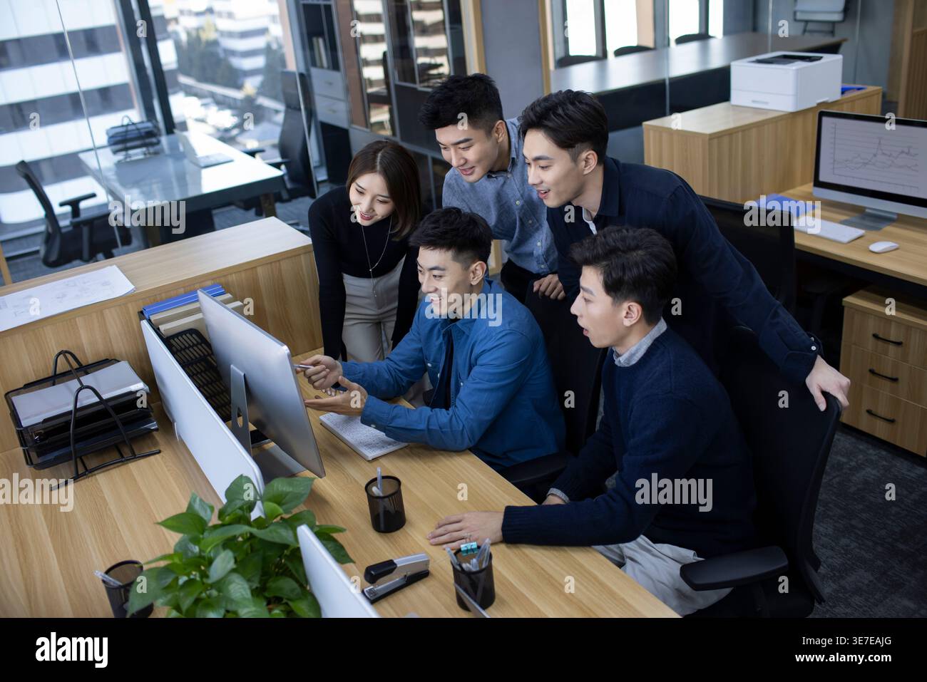 Chinese IT experts working together on computer in office Stock Photo